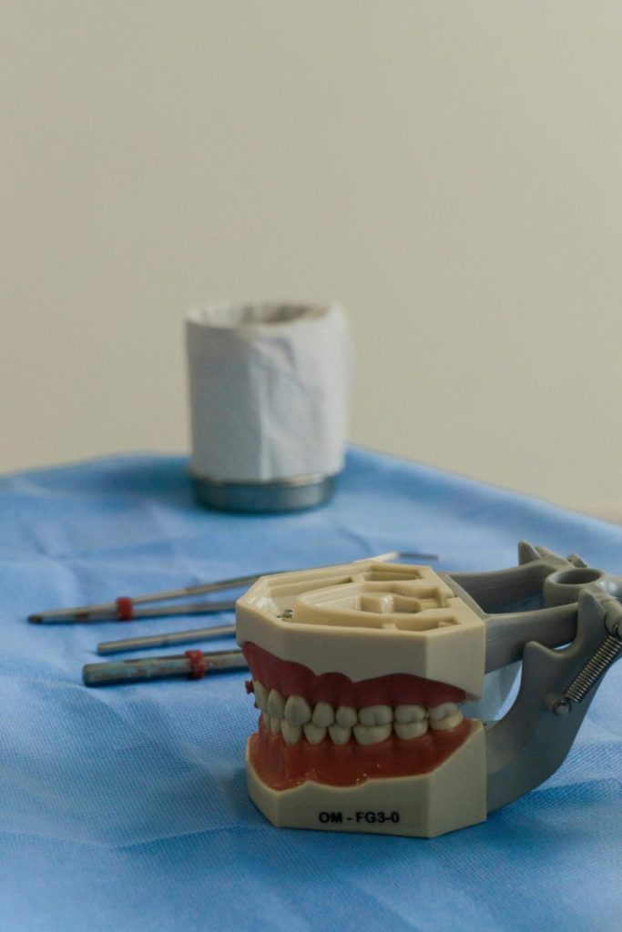 Close-up of dental tools and model teeth on a clinic table, illustrating professional dentistry setup.
